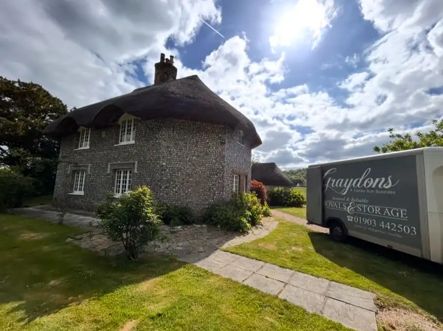 Van outside a cottage.