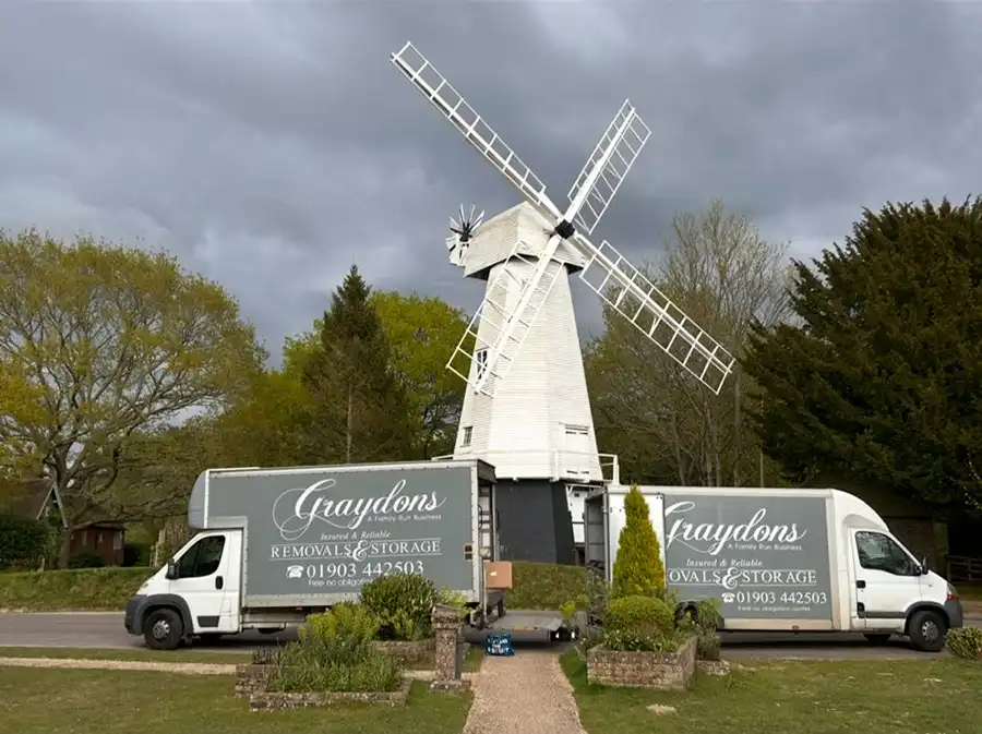 2 vans outside a windmill.